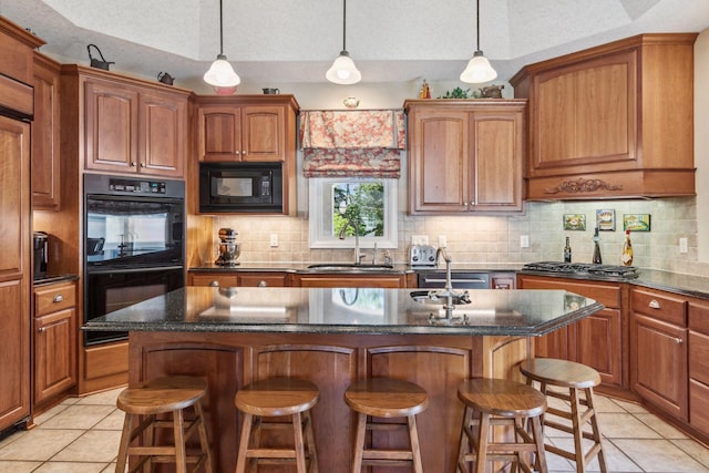 130 Stonebridge Rd, Lilydale, MN 55118 - kitchen with black appliances, light tile patterned floors, a breakfast bar, and tasteful backsplash