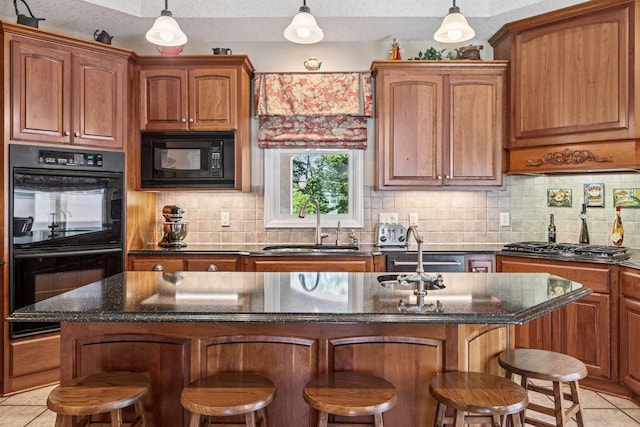 130 Stonebridge Rd, Lilydale, MN 55118 - kitchen with black appliances, light tile patterned floors, a sink, a breakfast bar, and tasteful backsplash