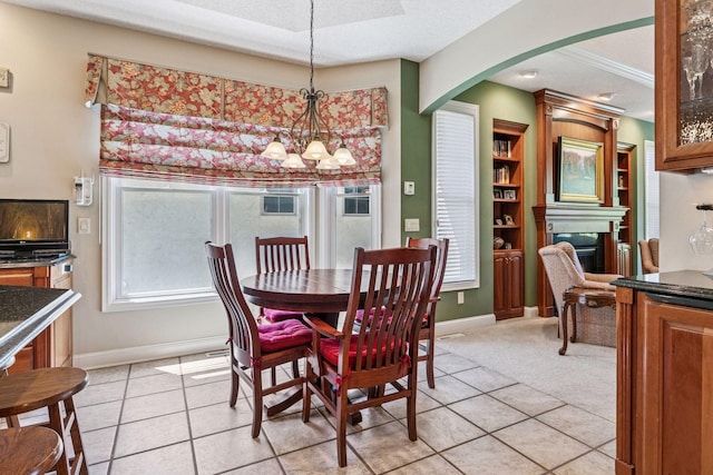 130 Stonebridge Rd, Lilydale, MN 55118 - dining area with a chandelier, a glass covered fireplace, light tile patterned floors, and baseboards