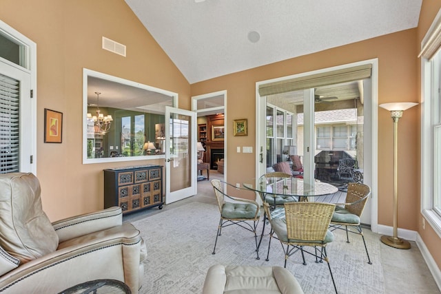 130 Stonebridge Rd, Lilydale, MN 55118 - carpeted dining room featuring a chandelier, baseboards, a ceiling fan, and high vaulted ceiling
