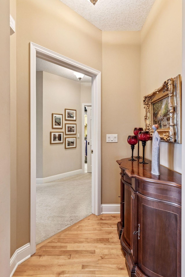 130 Stonebridge Rd, Lilydale, MN 55118 - corridor featuring a textured ceiling, light wood finished floors, and baseboards