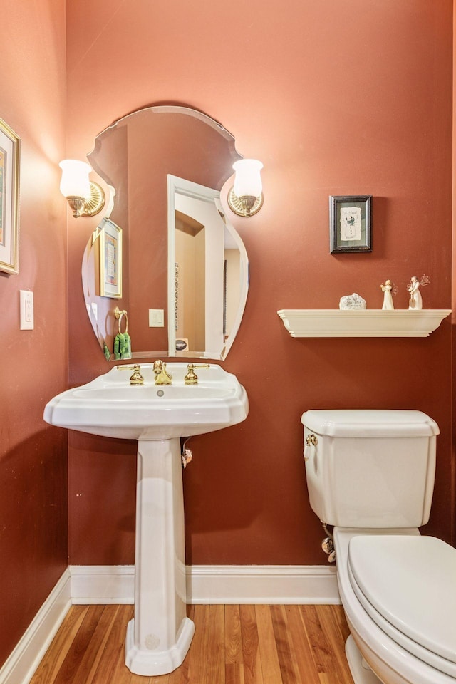 130 Stonebridge Rd, Lilydale, MN 55118 - half bath with baseboards, toilet, and wood finished floors