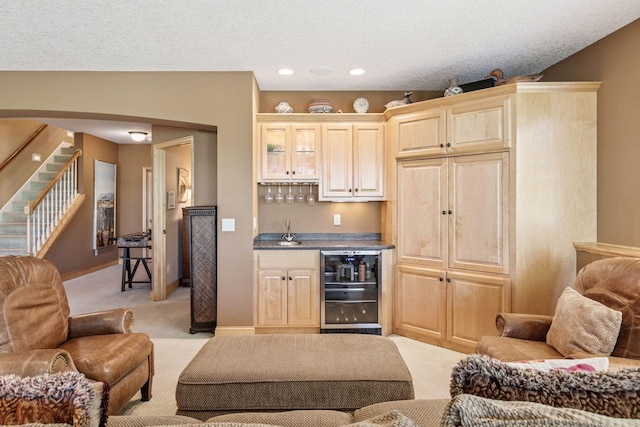130 Stonebridge Rd, Lilydale, MN 55118 - indoor wet bar featuring beverage cooler, light colored carpet, stairs, arched walkways, and baseboards