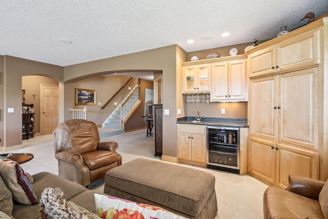 130 Stonebridge Rd, Lilydale, MN 55118 - living room with beverage cooler, arched walkways, light carpet, wet bar, and a textured ceiling