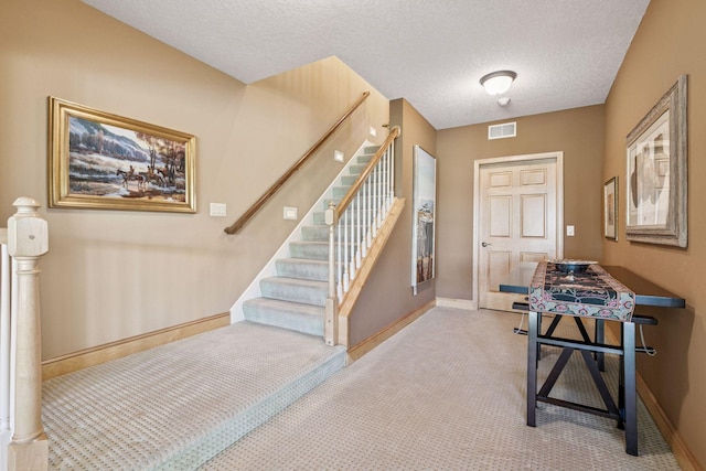 130 Stonebridge Rd, Lilydale, MN 55118 - foyer entrance with baseboards, carpet, stairway, and a textured ceiling