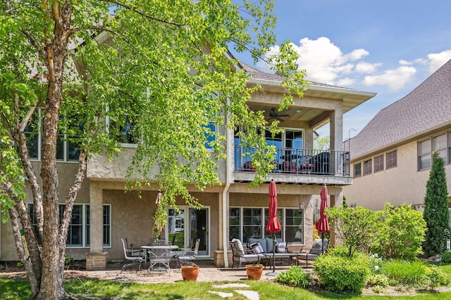 130 Stonebridge Rd, Lilydale, MN 55118 - rear view of property featuring a balcony, ceiling fan, stucco siding, a patio area, and an outdoor hangout area