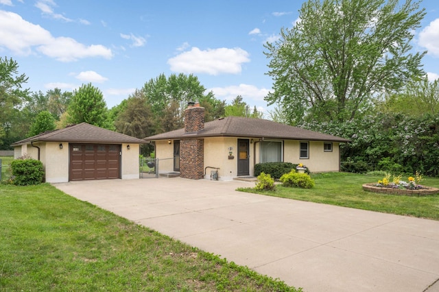 view of front facade with a detached garage, driveway, a chimney, stucco siding, and a gate