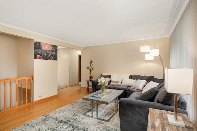 living area with wood finished floors, crown molding, and baseboards