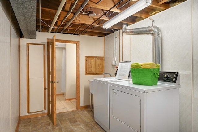 laundry area featuring washer and dryer and baseboards