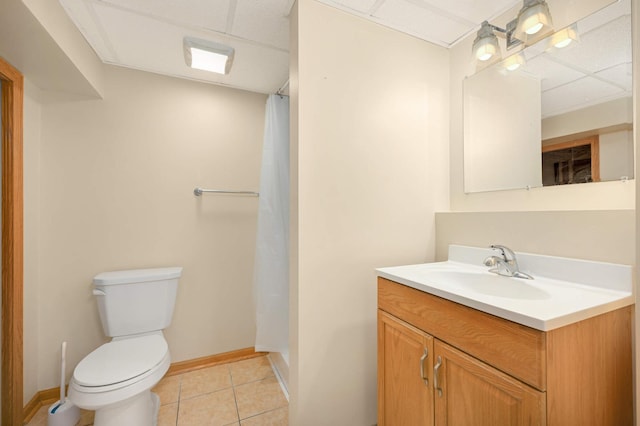 bathroom with toilet, tile patterned floors, vanity, and baseboards