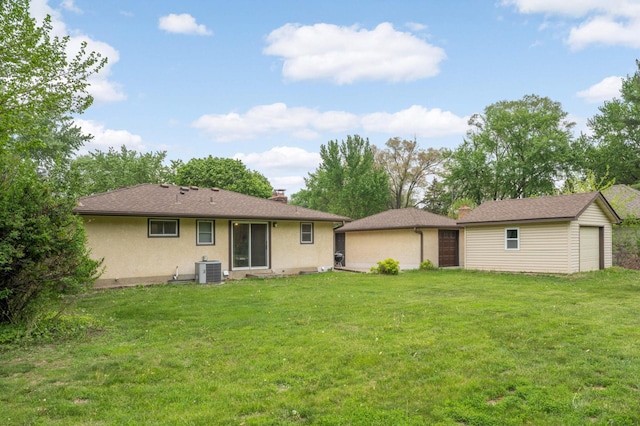 back of property featuring cooling unit, stucco siding, a lawn, an outdoor structure, and a chimney