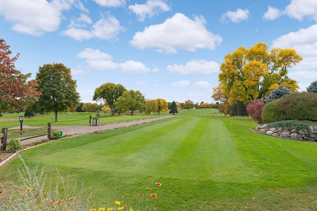 view of community with a lawn and golf course view