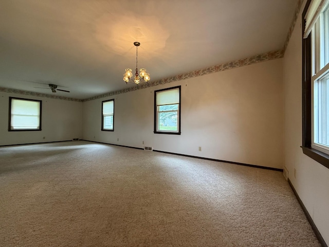 421 Oxford St W, Worthington, MN 56187 - empty room featuring light carpet, baseboards, and a chandelier