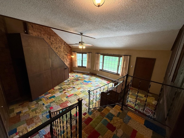 421 Oxford St W, Worthington, MN 56187 - bedroom with a textured ceiling, carpet floors, baseboard heating, and a ceiling fan