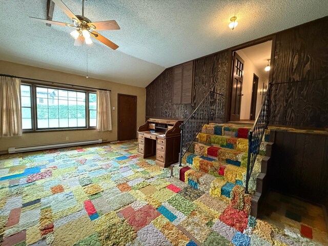 421 Oxford St W, Worthington, MN 56187 - living area with baseboard heating, ceiling fan, a textured ceiling, stairs, and lofted ceiling