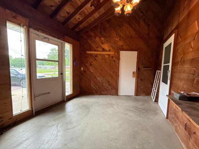 421 Oxford St W, Worthington, MN 56187 - foyer featuring lofted ceiling, wood walls, wooden ceiling, and concrete flooring