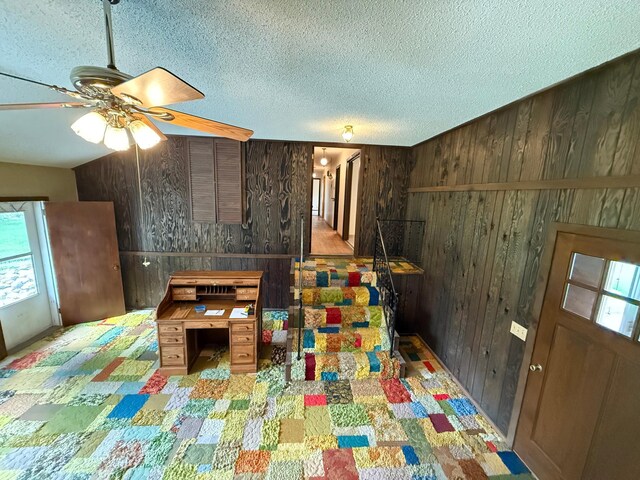 421 Oxford St W, Worthington, MN 56187 - living room with wooden walls, ceiling fan, and a textured ceiling