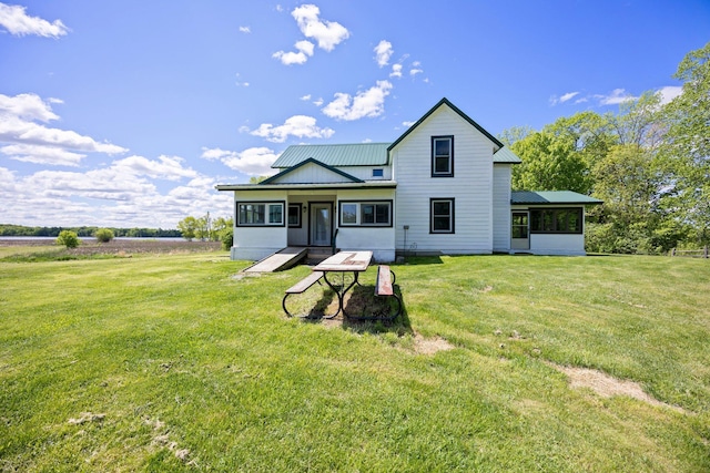 3592 Blom Lake Dr, Frederic, WI 54837 - back of house with a yard, a sunroom, and metal roof