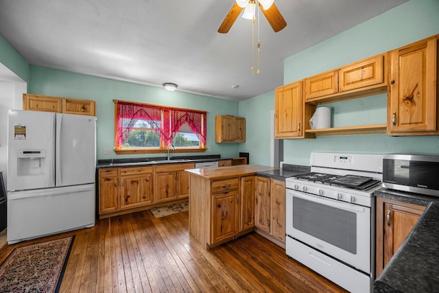 3592 Blom Lake Dr, Frederic, WI 54837 - kitchen featuring white appliances, a sink, dark countertops, and dark wood-style flooring