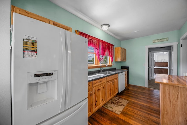 3592 Blom Lake Dr, Frederic, WI 54837 - kitchen with white appliances, a sink, dark wood finished floors, and dark countertops