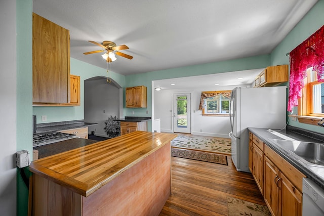 3592 Blom Lake Dr, Frederic, WI 54837 - kitchen featuring a sink, white appliances, dark wood-style flooring, a ceiling fan, and wooden counters