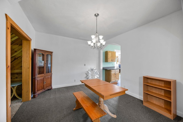 3592 Blom Lake Dr, Frederic, WI 54837 - dining space with a chandelier, dark colored carpet, and baseboards