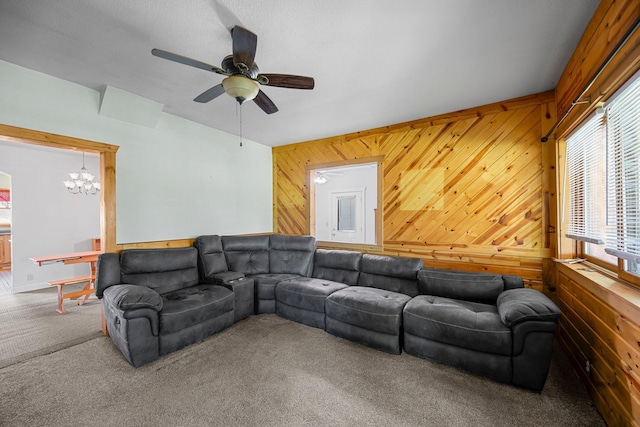 3592 Blom Lake Dr, Frederic, WI 54837 - living room with carpet flooring, wooden walls, ceiling fan, and a chandelier