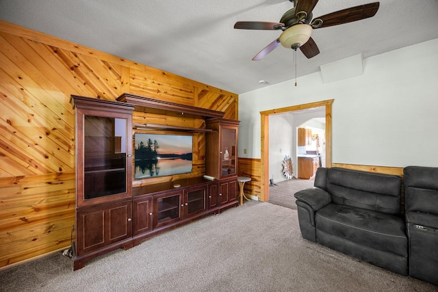 3592 Blom Lake Dr, Frederic, WI 54837 - carpeted living area featuring wooden walls and a ceiling fan