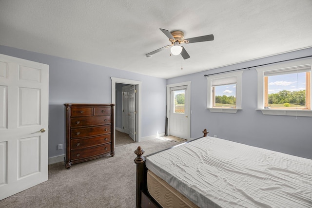3592 Blom Lake Dr, Frederic, WI 54837 - bedroom with light carpet, baseboards, ceiling fan, and a textured ceiling