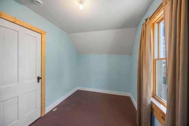 3592 Blom Lake Dr, Frederic, WI 54837 - bonus room featuring vaulted ceiling, baseboards, and dark wood-style flooring