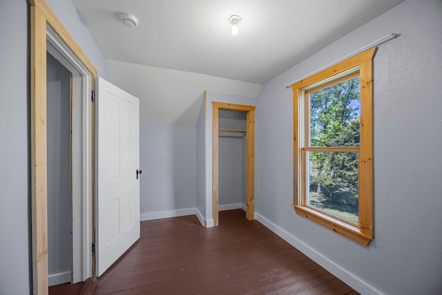 3592 Blom Lake Dr, Frederic, WI 54837 - unfurnished bedroom featuring dark wood-style flooring, baseboards, and a closet