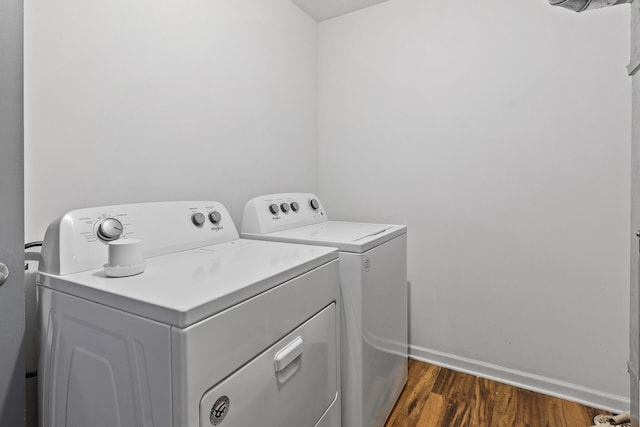 laundry area with independent washer and dryer, dark wood-style flooring, and baseboards