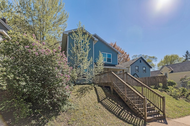 back of house with stairs and fence