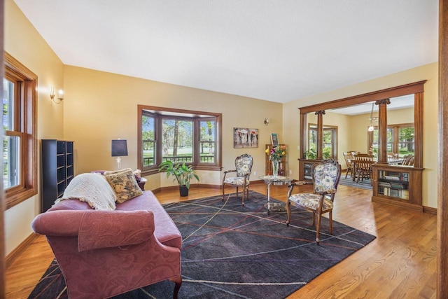 living area with wood finished floors and baseboards