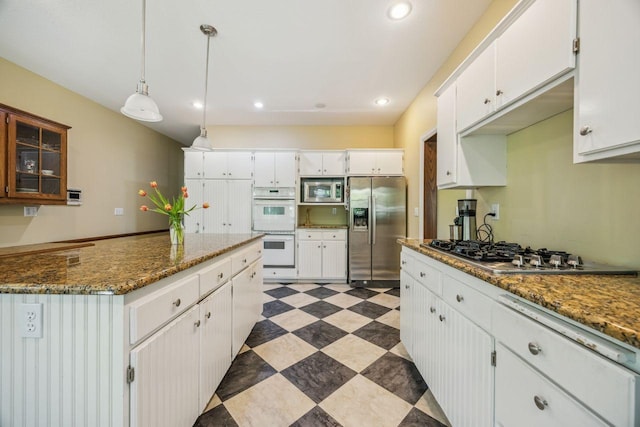 kitchen with stainless steel appliances, white cabinetry, recessed lighting, light flooring, and decorative light fixtures