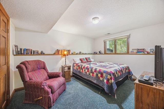 bedroom featuring carpet flooring and a textured ceiling
