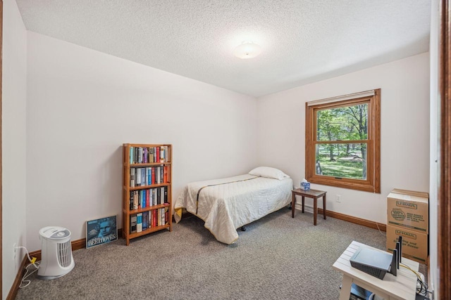 bedroom featuring carpet flooring, a textured ceiling, and baseboards