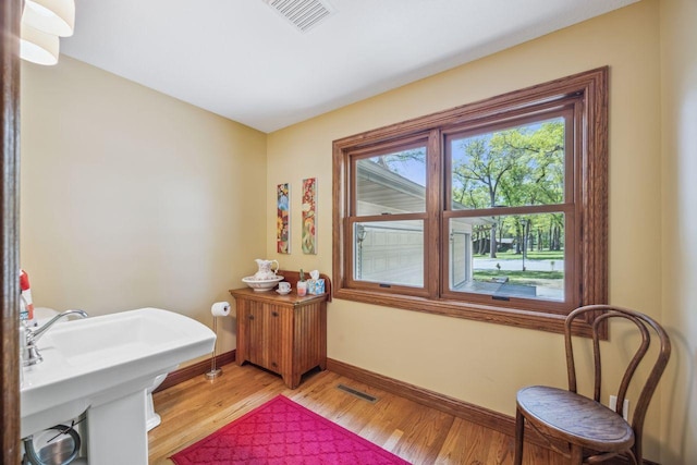 bathroom with baseboards and wood finished floors