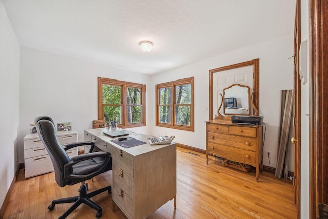office area with light wood-type flooring and baseboards