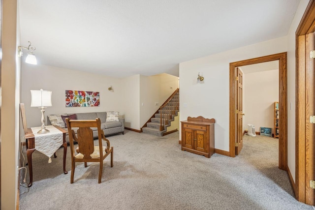 living room with light carpet, stairway, and baseboards