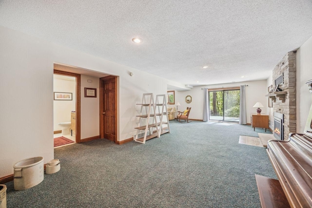 living area with carpet, a textured ceiling, a fireplace, and recessed lighting