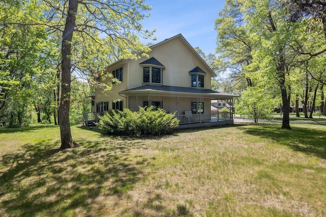 view of front of property with a porch and a front lawn