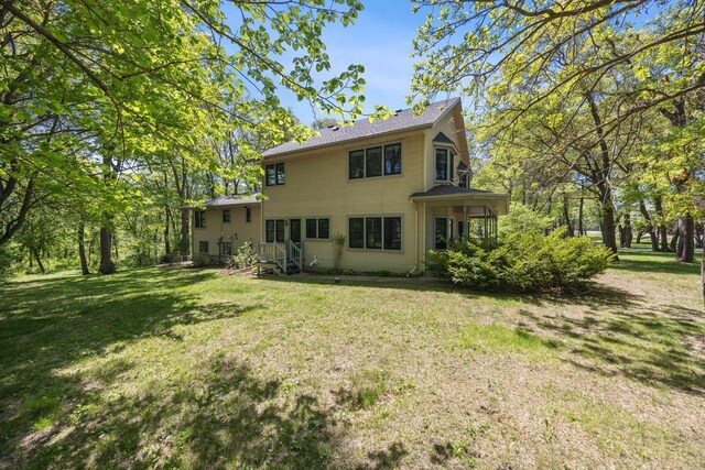 rear view of house with a yard