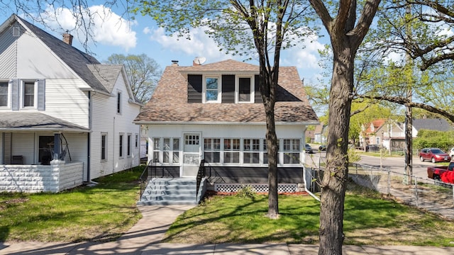 view of front of house featuring roof with shingles and a chimney