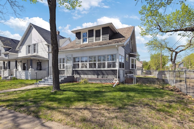 view of front of house with a shingled roof and a gate