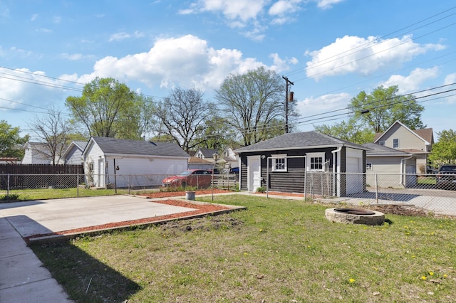 view of yard with a fire pit, an outbuilding, and a patio