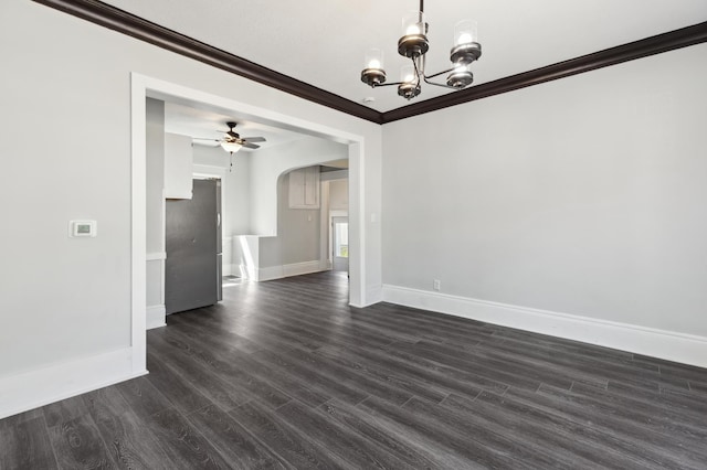 unfurnished dining area with arched walkways, baseboards, a ceiling fan, ornamental molding, and dark wood-style flooring