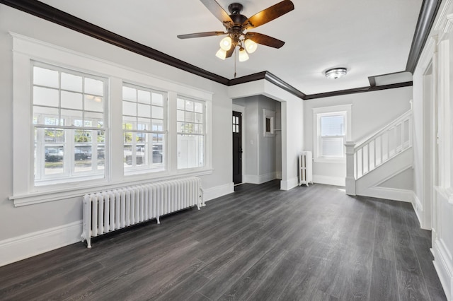 983 Sherburne Ave, Saint Paul, MN 55104 - unfurnished living room featuring radiator heating unit, stairs, a ceiling fan, dark wood-style floors, and crown molding