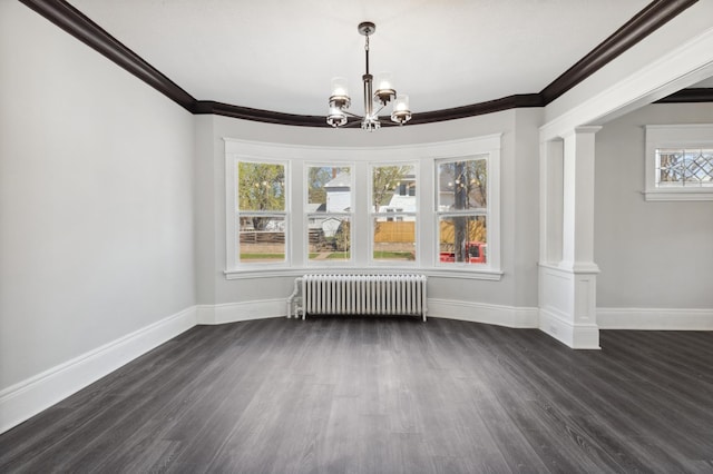 983 Sherburne Ave, Saint Paul, MN 55104 - unfurnished dining area with radiator heating unit, decorative columns, ornamental molding, baseboards, and dark wood-style floors