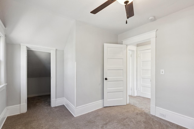 983 Sherburne Ave, Saint Paul, MN 55104 - unfurnished bedroom featuring carpet, a spacious closet, a ceiling fan, and baseboards